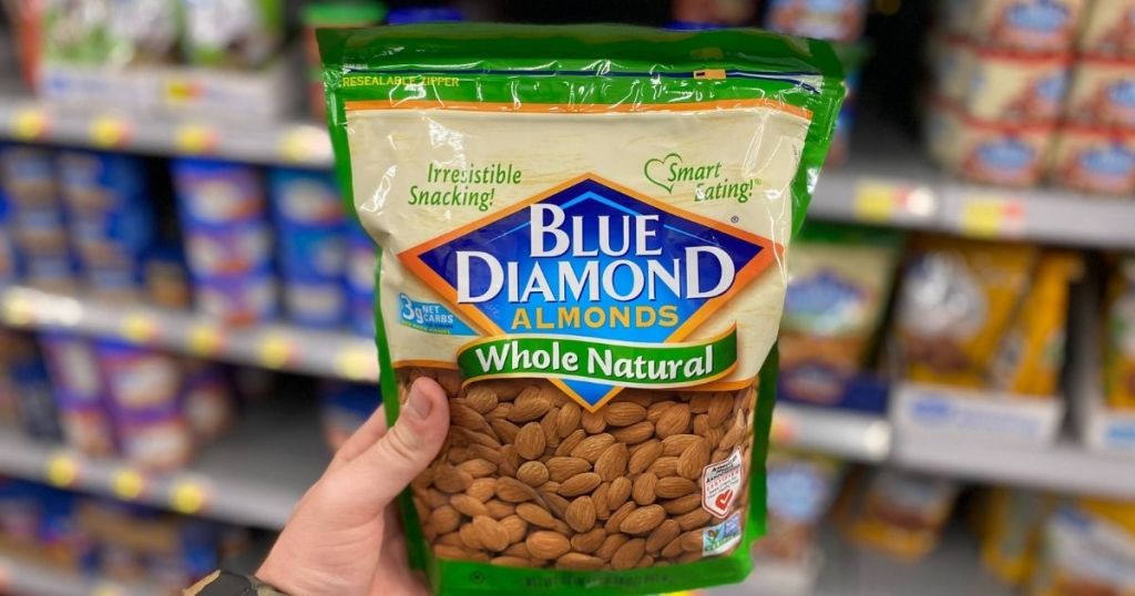 hand holding a bag of Blue diamond almonds