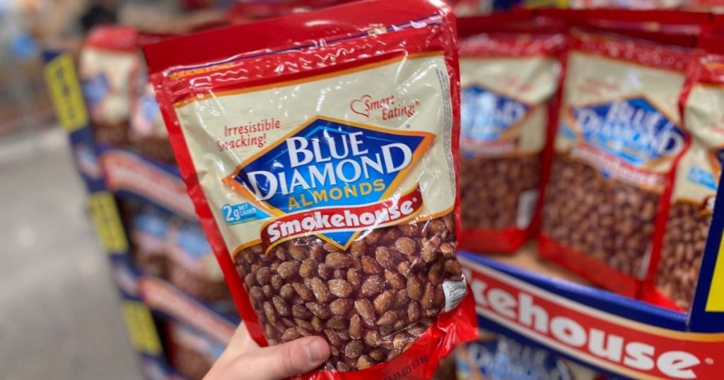 hand holding a bag of Blue Diamond almonds