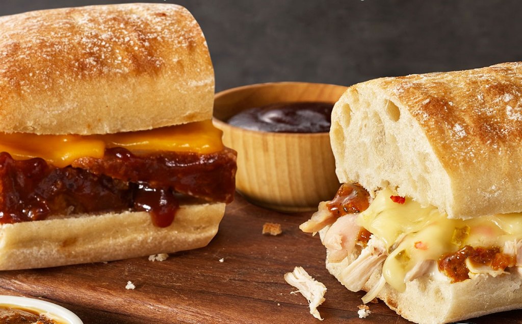 two boston market sandwich sliders on wood cutting board with dipping sauce