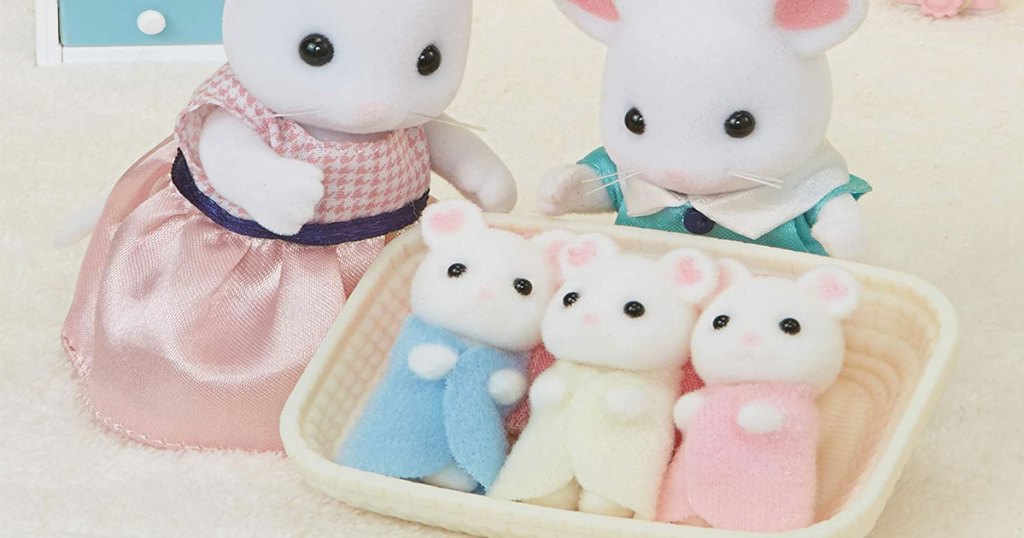 three calico critters baby mice in basket with parent mice looking after them