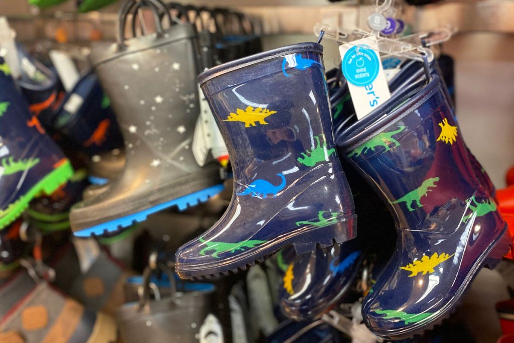pairs of printed boys rain boots on carter's store display