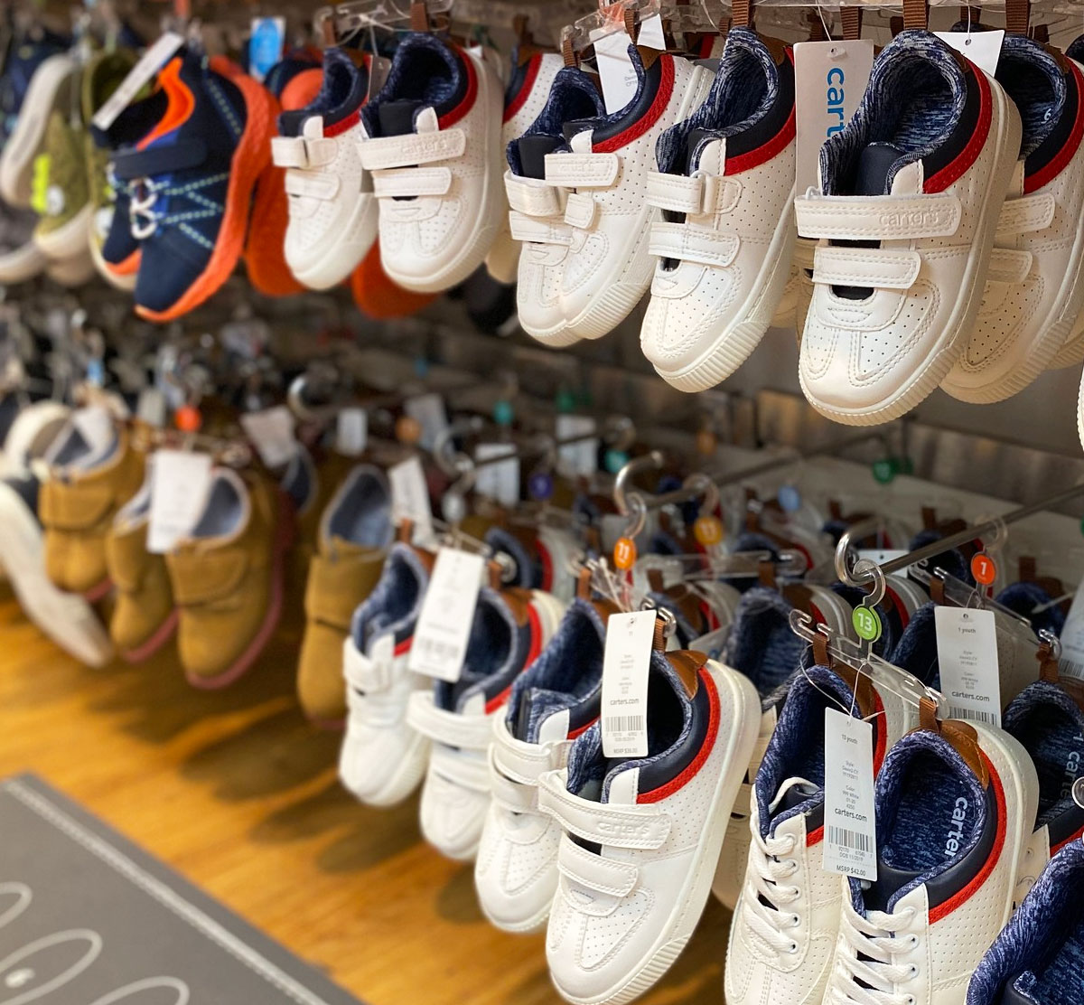 pairs of white velcro boys sneakers on display at carter's