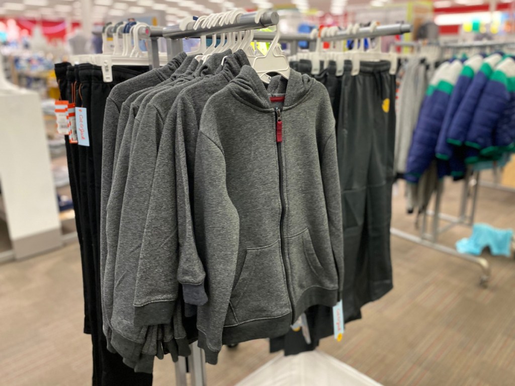 boys fleece sweatshirt hanging on a rack at target next to fleece pants joggers