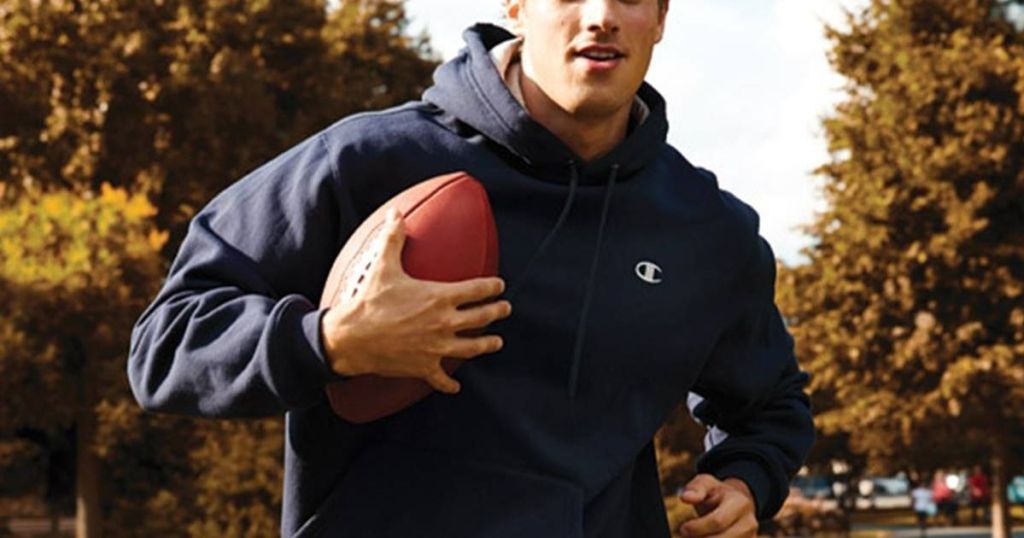 Champion Hoodie on man running with football
