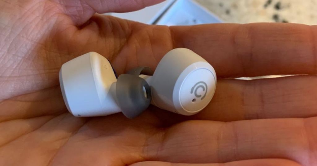 hand holding wireless earbuds