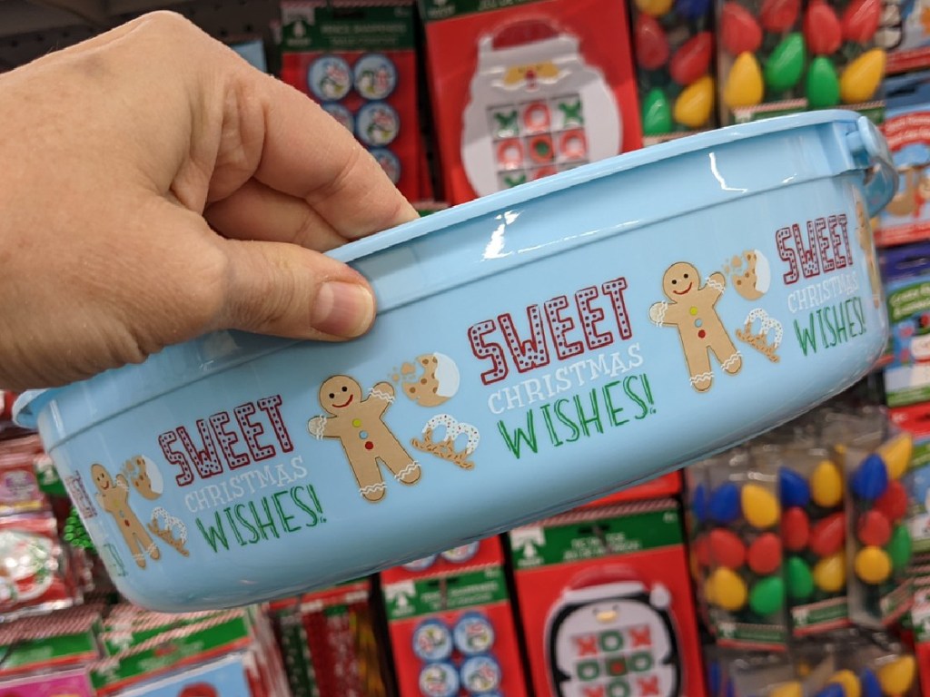hand holding plastic bowl with Gingerbread men on it