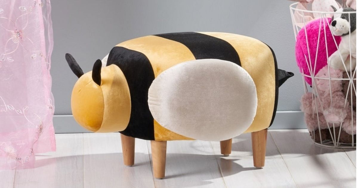 Christopher Knight Bee Ottoman next to a wire basket of toys
