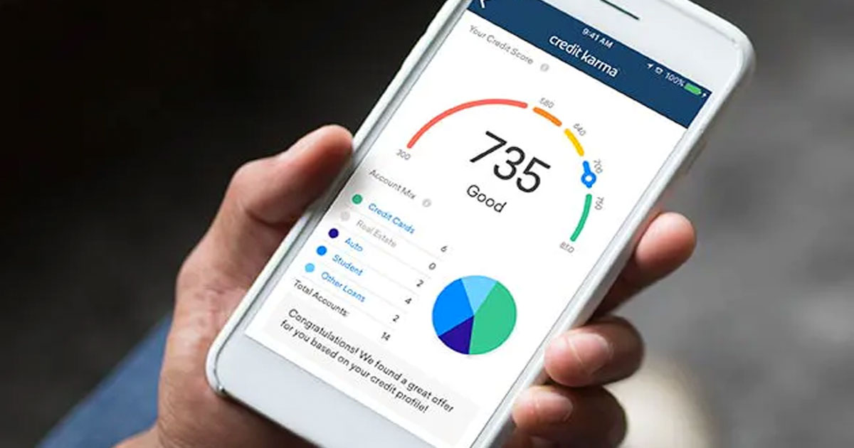person holding white iphone with credit karma app showing credit score