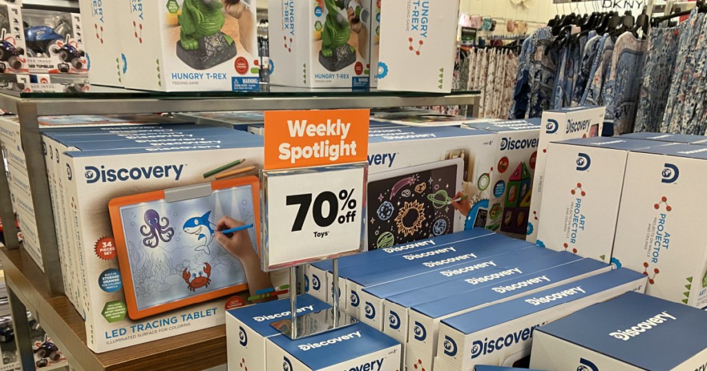 various kids toys and games on store display with sale sign