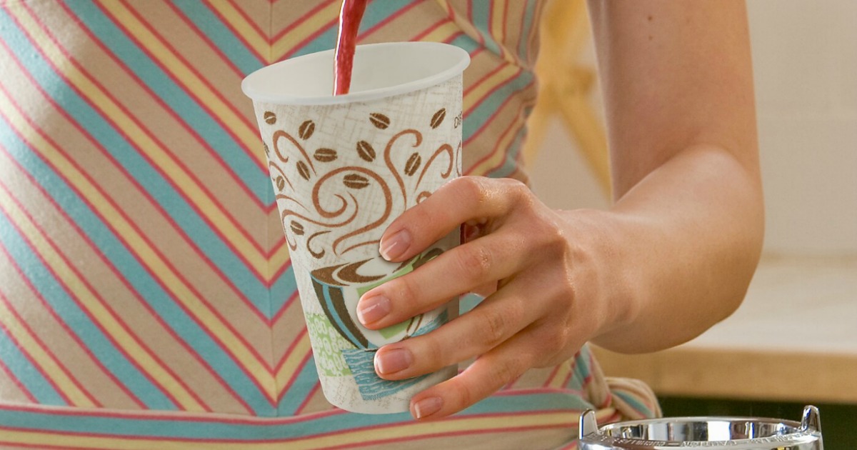 Woman's hand holding a large Dixie cup