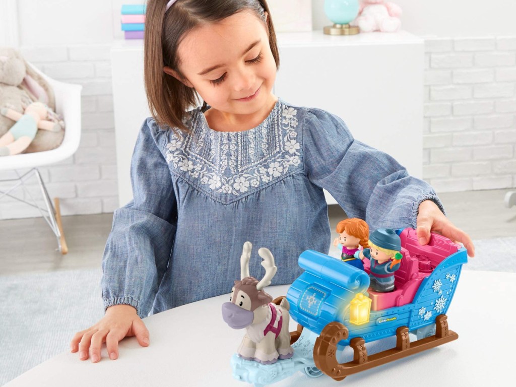 little girl playing with fisher price kristoff's little people sleigh