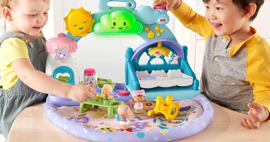2 toddlers playing with a fisher price babies playdate playset