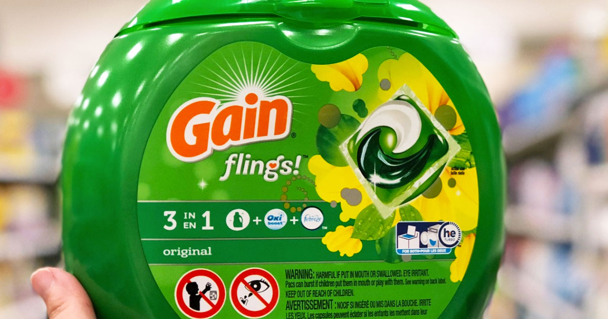 person holding up green container of gain flings