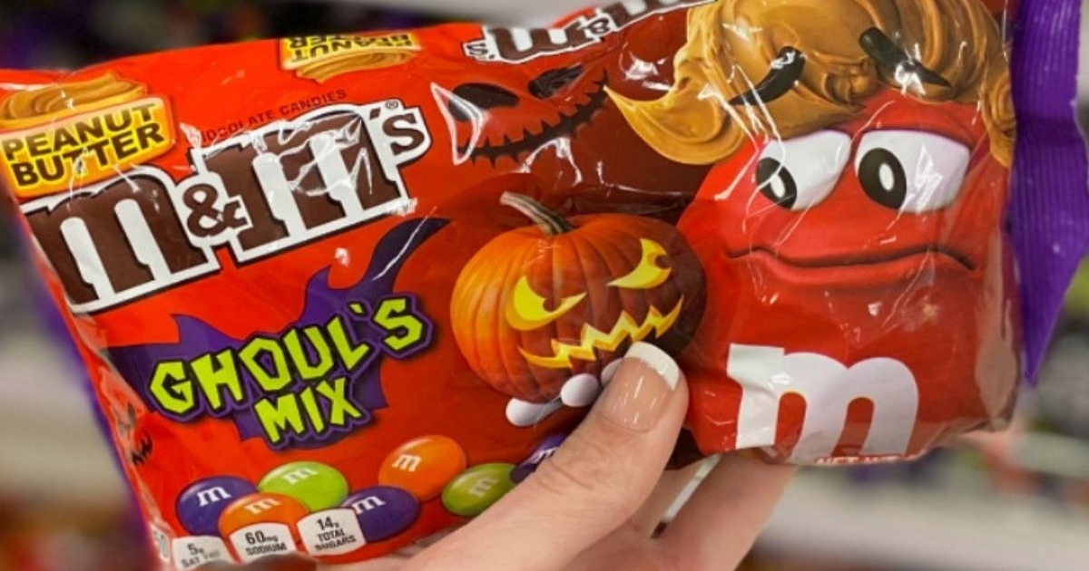 M&M's Ghouls mix, halloween candy bag held by a hand in store