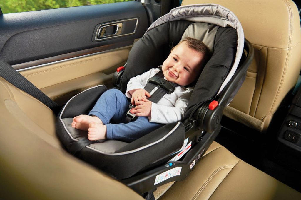 baby in a graco infant car seat inside car