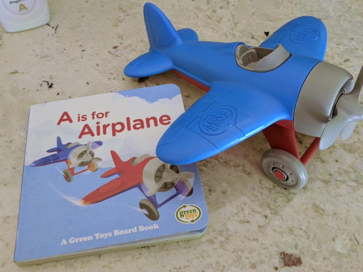 green toys airplane and board book