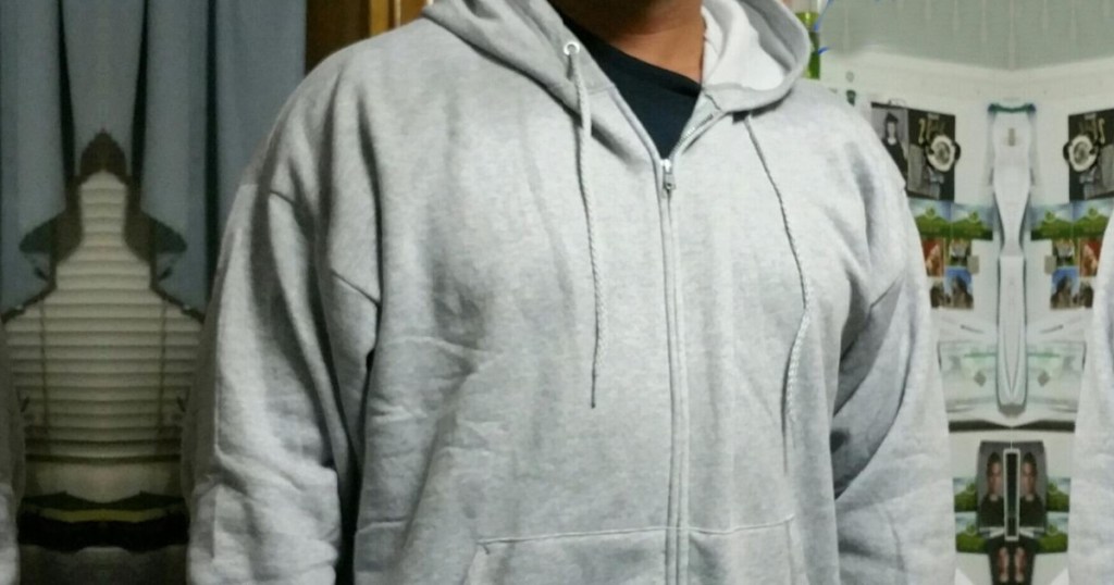 man wearing a light steel hanes zip up sweatshirt