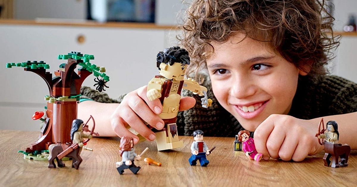 boy playing with Harry Potter Lego set