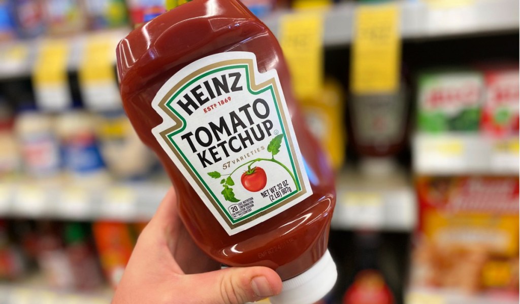 hand holding Heinz Ketchup 32-Ounce Bottles