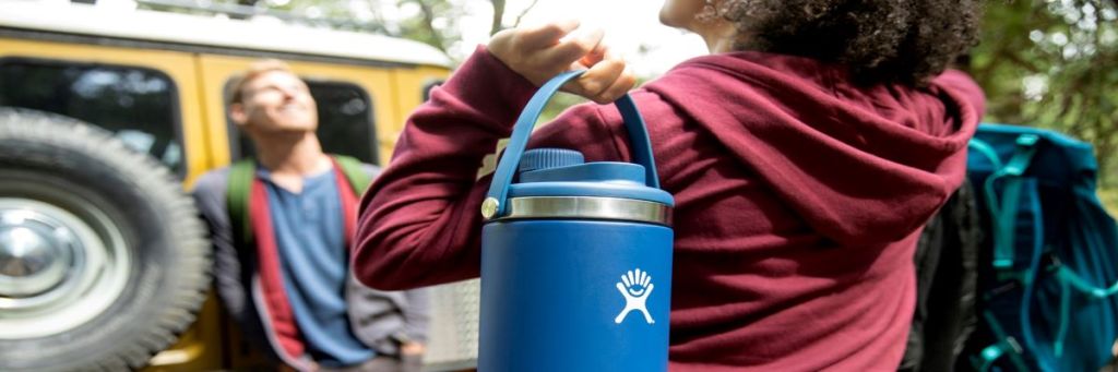 woman carrying a large Hydro Flask