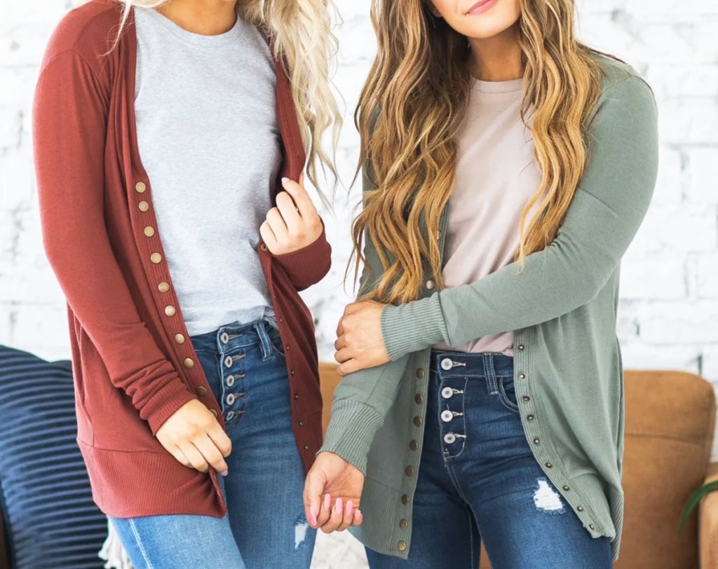 two girls modeling snap front cardigans with jeans and white t-shirts