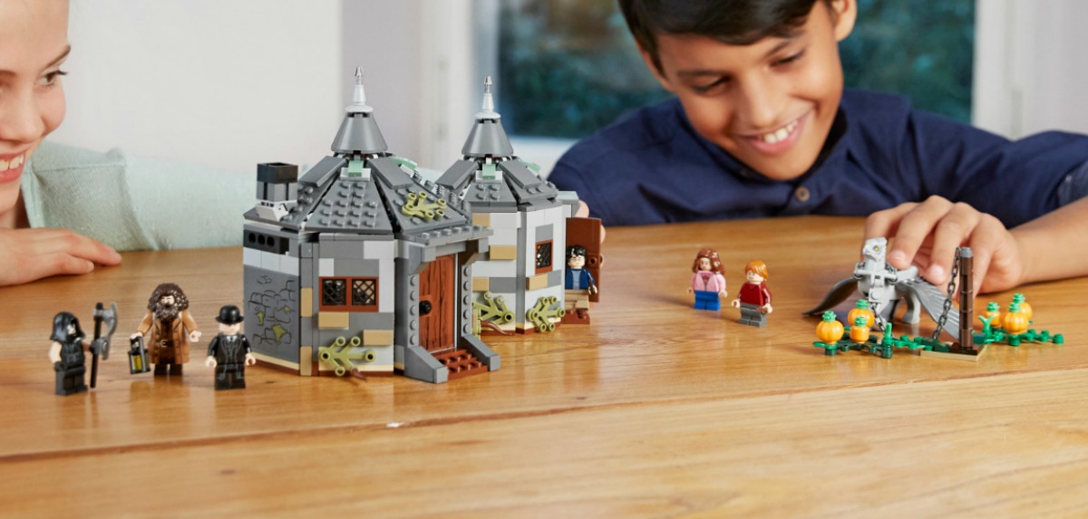 Two kids playing with a Harry Potter themed LEGO set