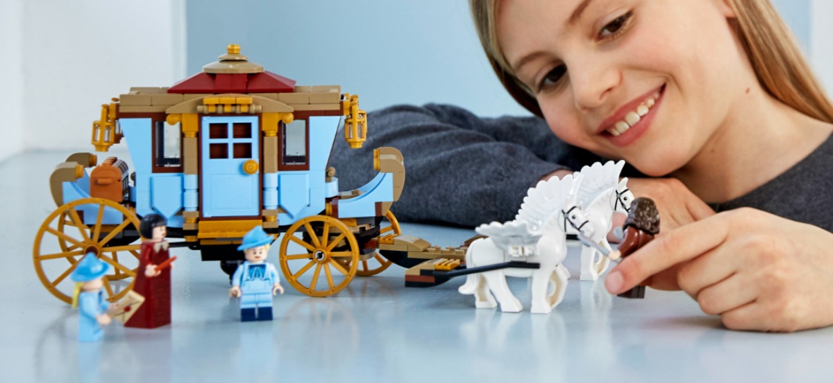 girl playing with LEGO carriage