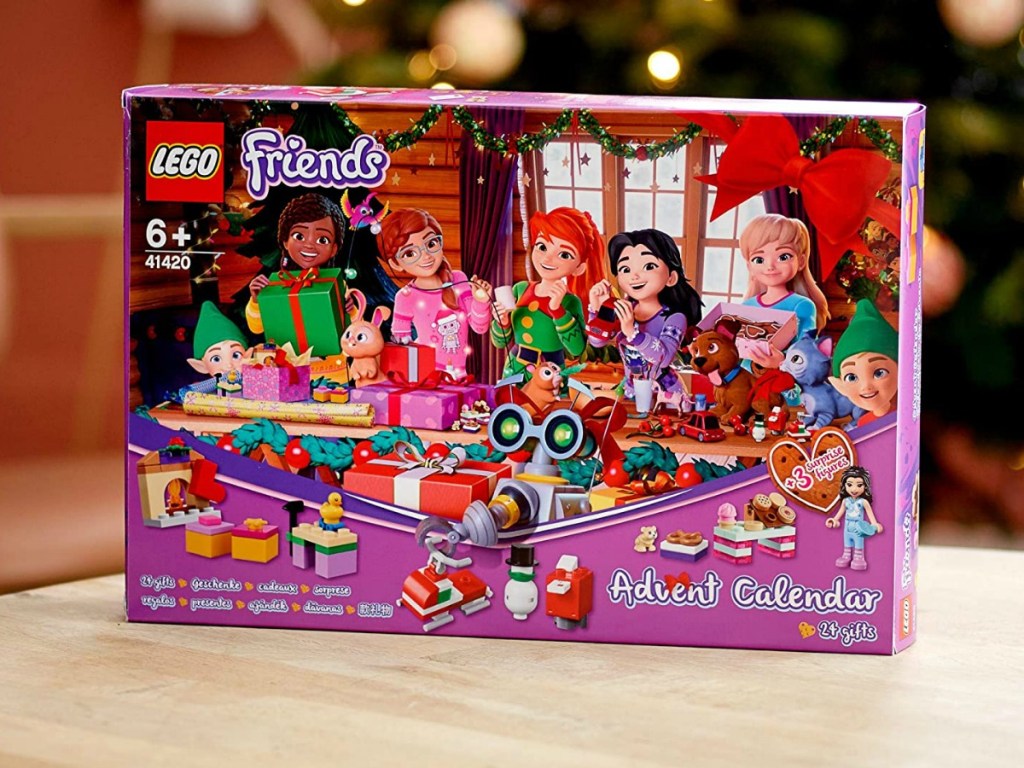 lego friends advent calendar on a counter with christmas tree in back