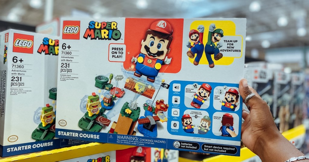 holding a Super Mario LEGO set