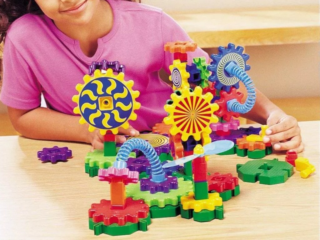Girl playing with a gear building set
