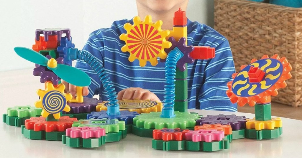Boy playing with gear building set