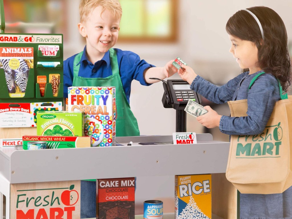 two children playing grocery store with melissa and doug grocery store playset