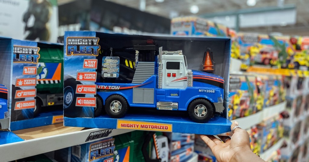 holding a boxed Mighty Fleet tow truck toy