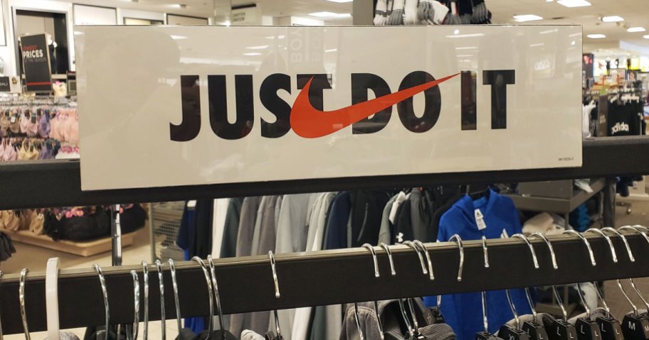 Nike Just Do It sign above Kohl's clothing rack