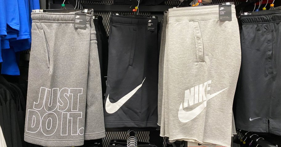pairs of nike basketball shorts on hangers on store display wall