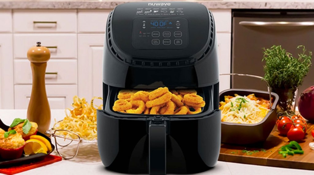 black NuWave air fryer on kitchen counter with basket full of onion rings