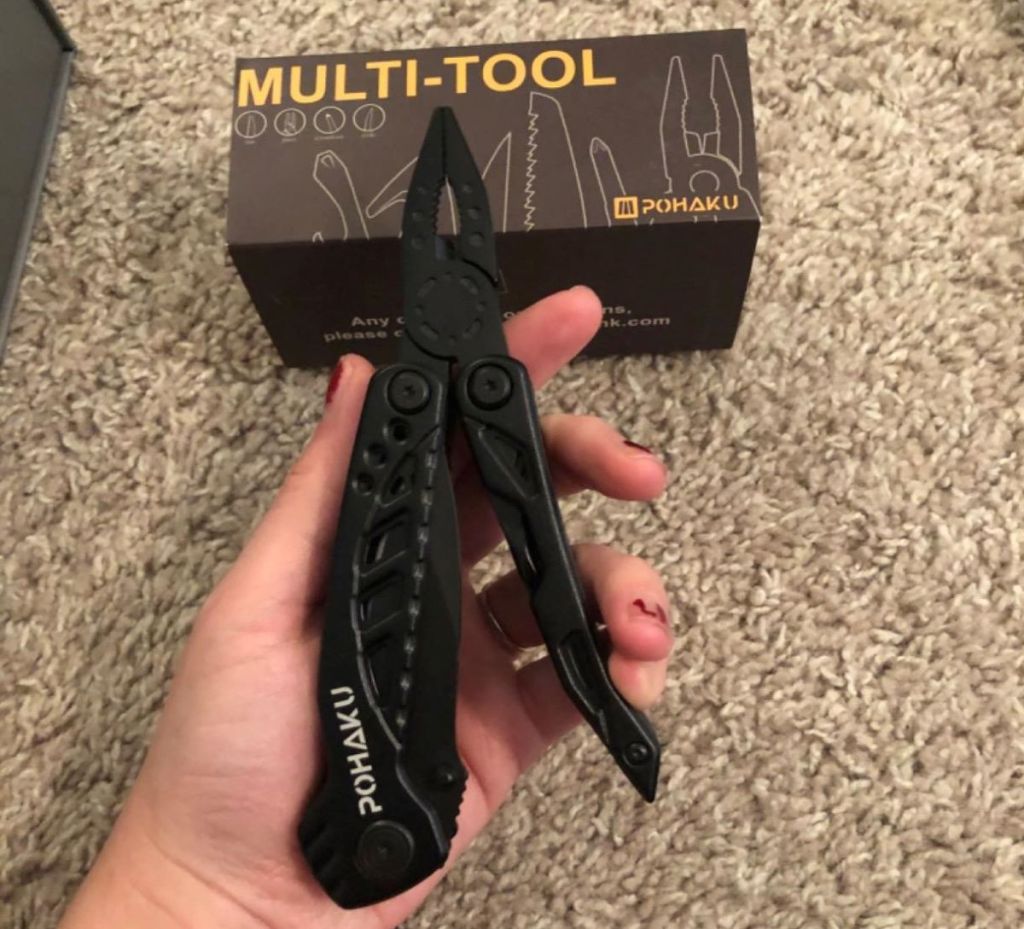 hand holding a knife multitool