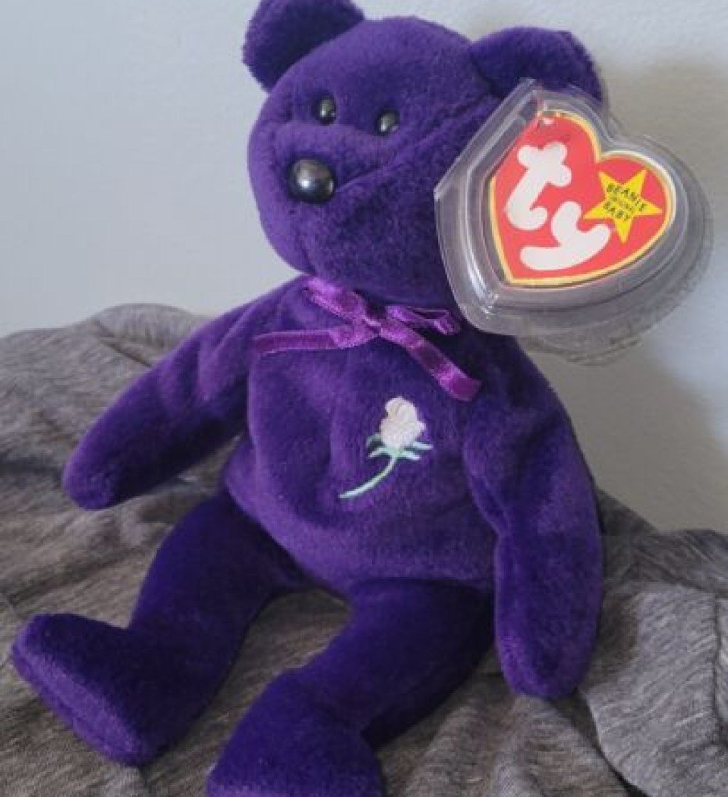 Princess the Bear Beanie Baby Vintage Toy with tag sitting on blanket