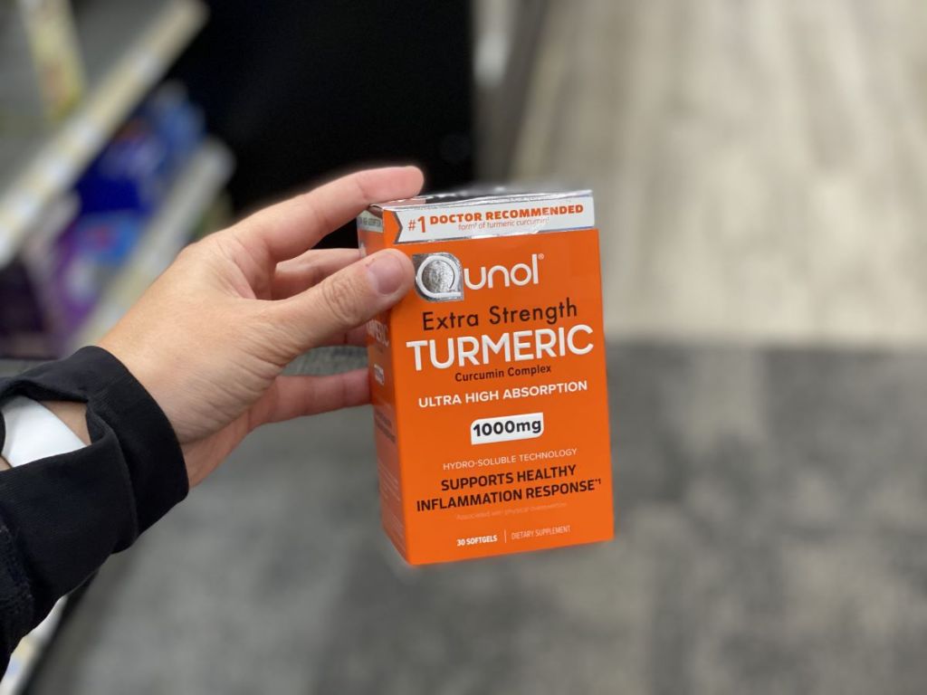 hand holding box of Qunol Turmeric vitamins