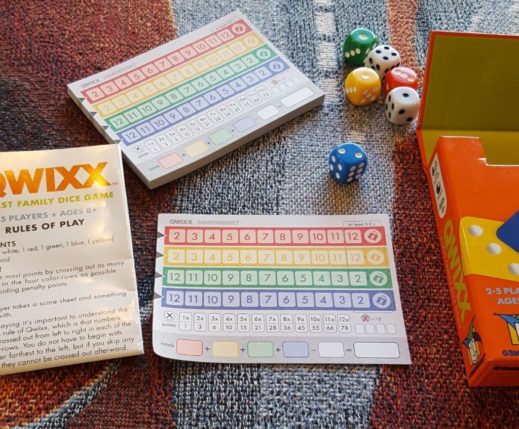 Qwixx game with scorecards and dice