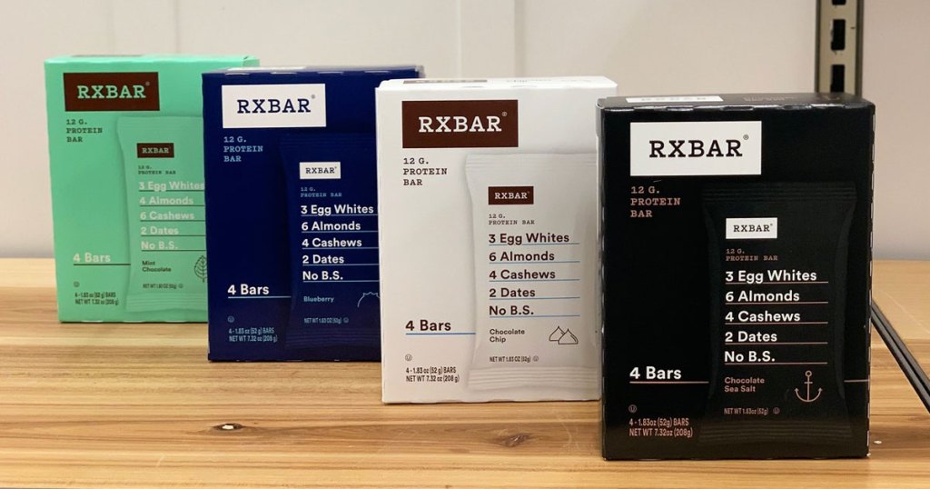boxes of RXbar protein bars in various flavors on a wood shelf