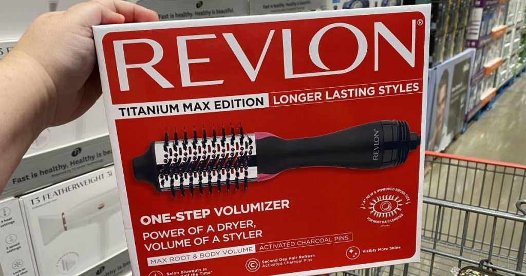 hand holding the box of a Revlon One-Step Titanium Max