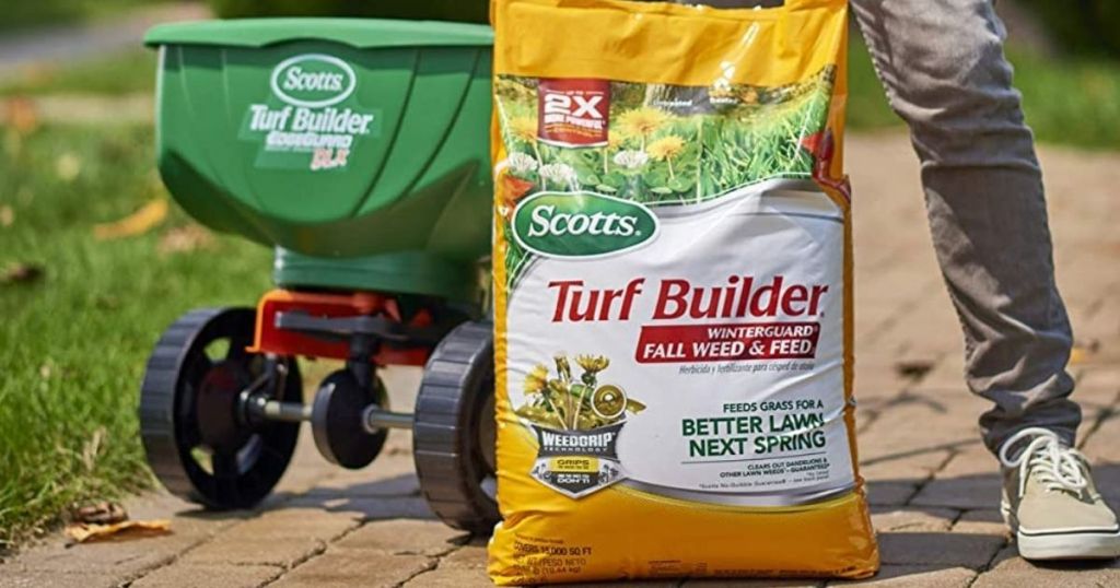 bag of lawn fertilizer by spreader cart