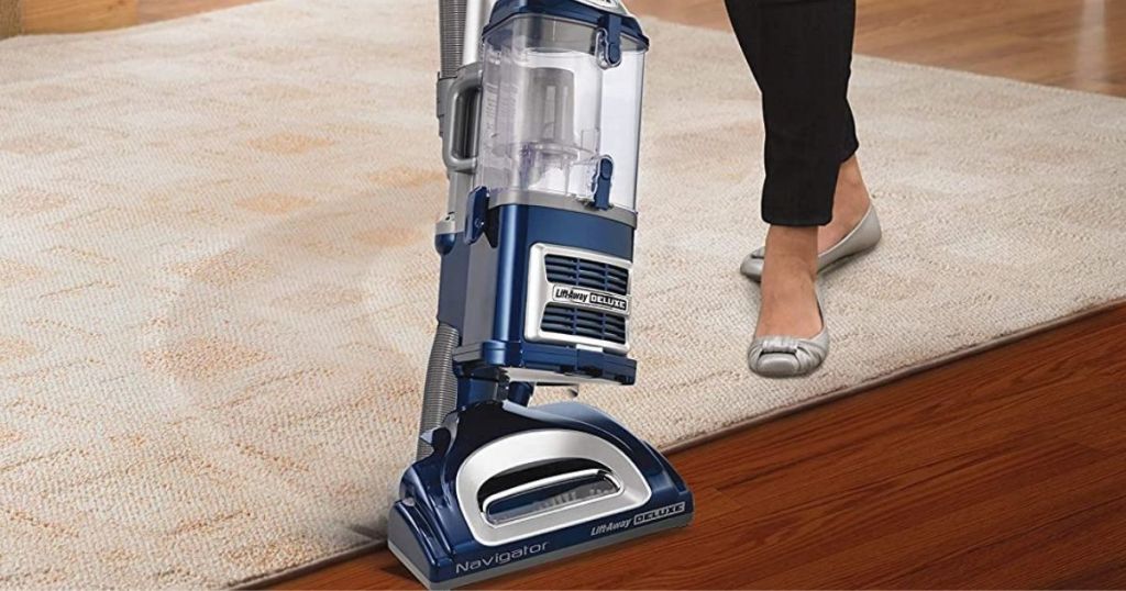 Shark navigator with lady vacuuming carpet to hardwood