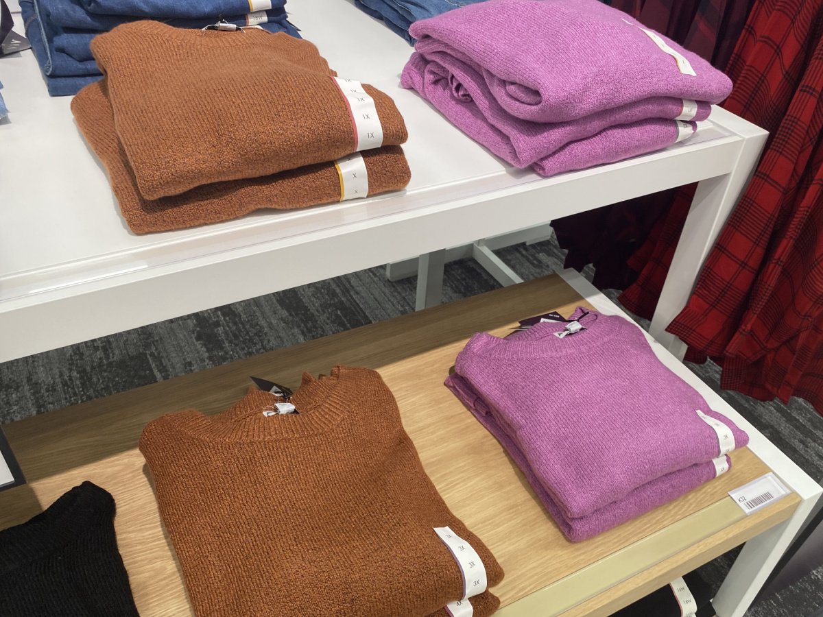 women's sweaters folded on a table at target