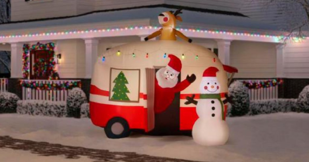 Santa, Reindeer, and Snowman with a large inflatable Christmas camper