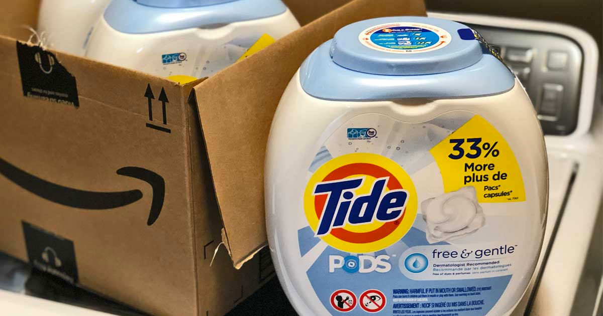 white container of tide free and gentle laundry detergent pods on washing machine near amazon box
