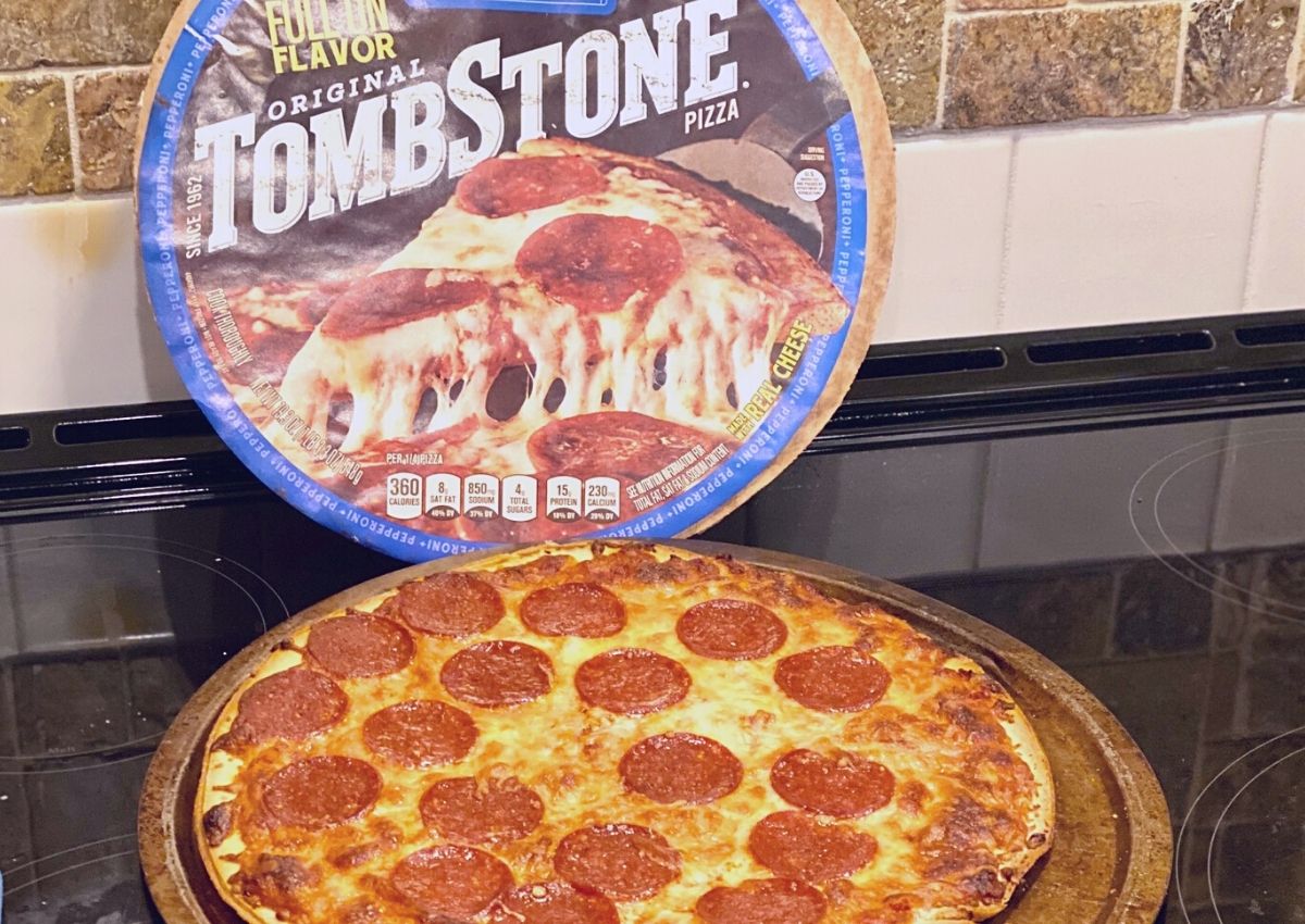 A Tombstone pizza on a stovetop