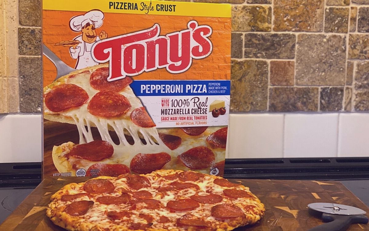 tony's pizza on a stovetop next to the original box