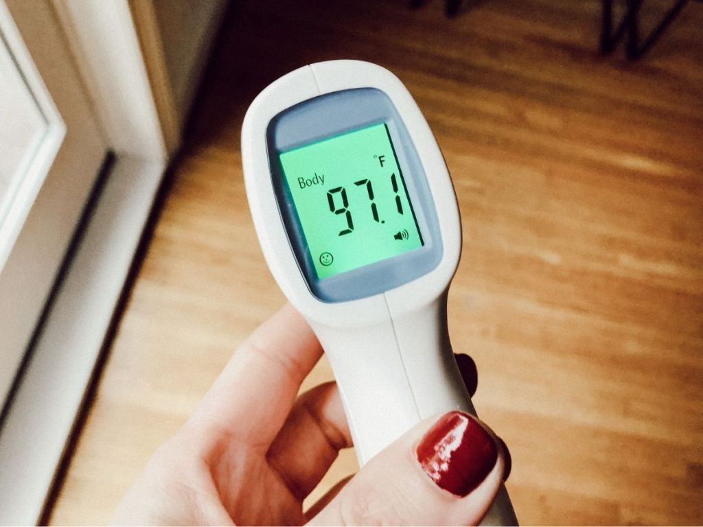 hand holding thermometer with screen reading 97.1